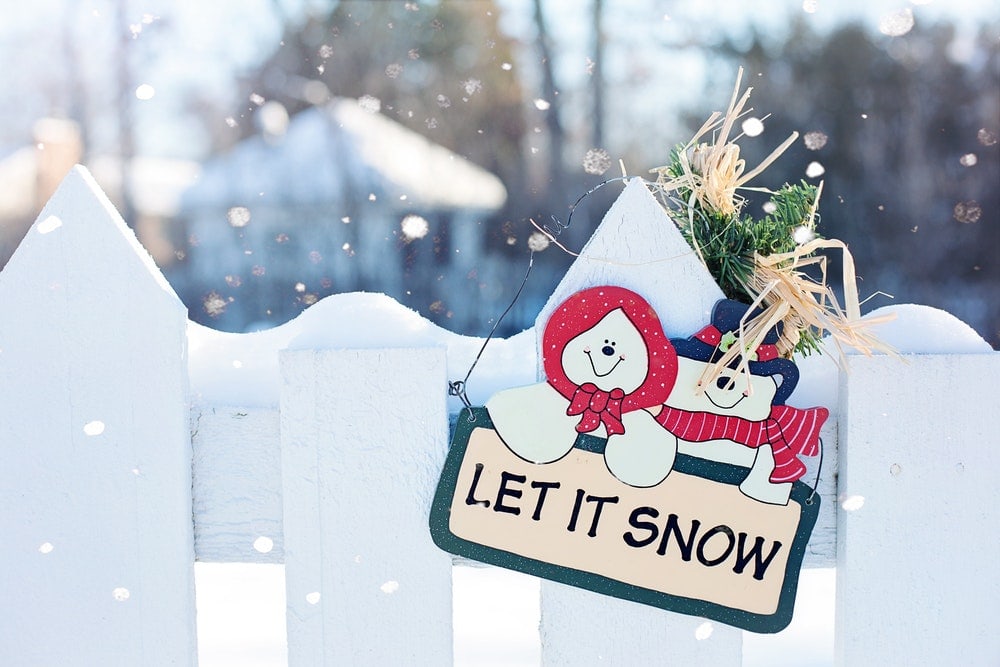 white fence with snow and christmas ornament