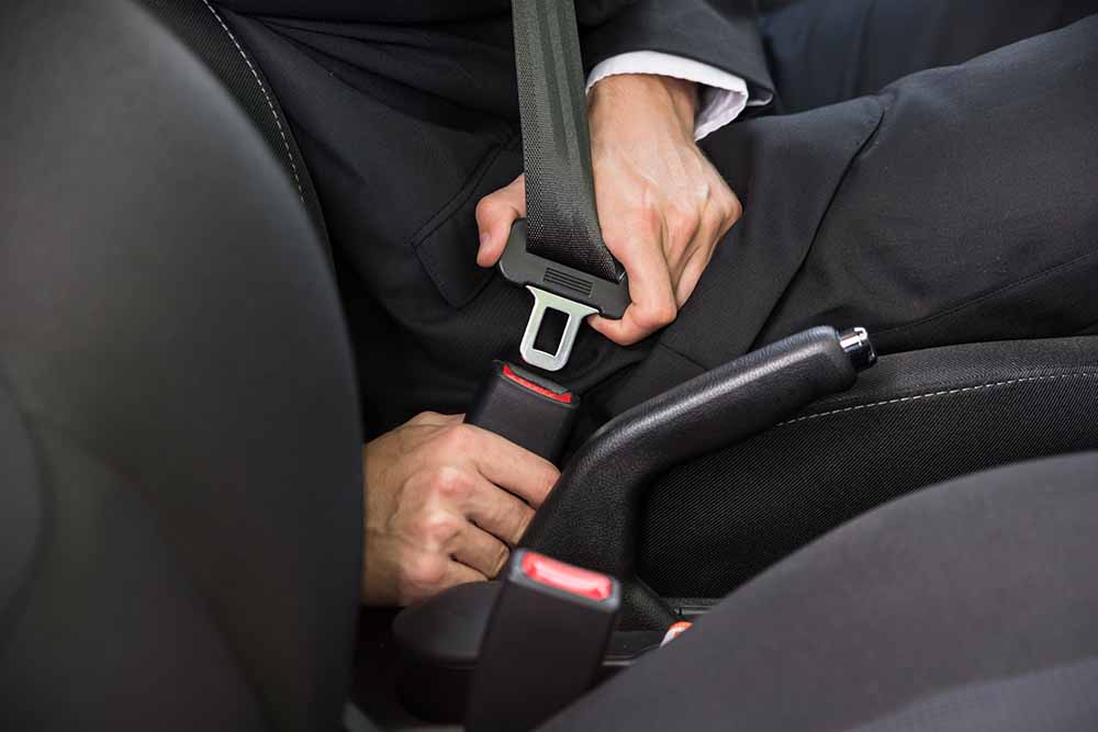 Close-up Of A Man Sitting In Car Fastening Seat Belt_Andrey