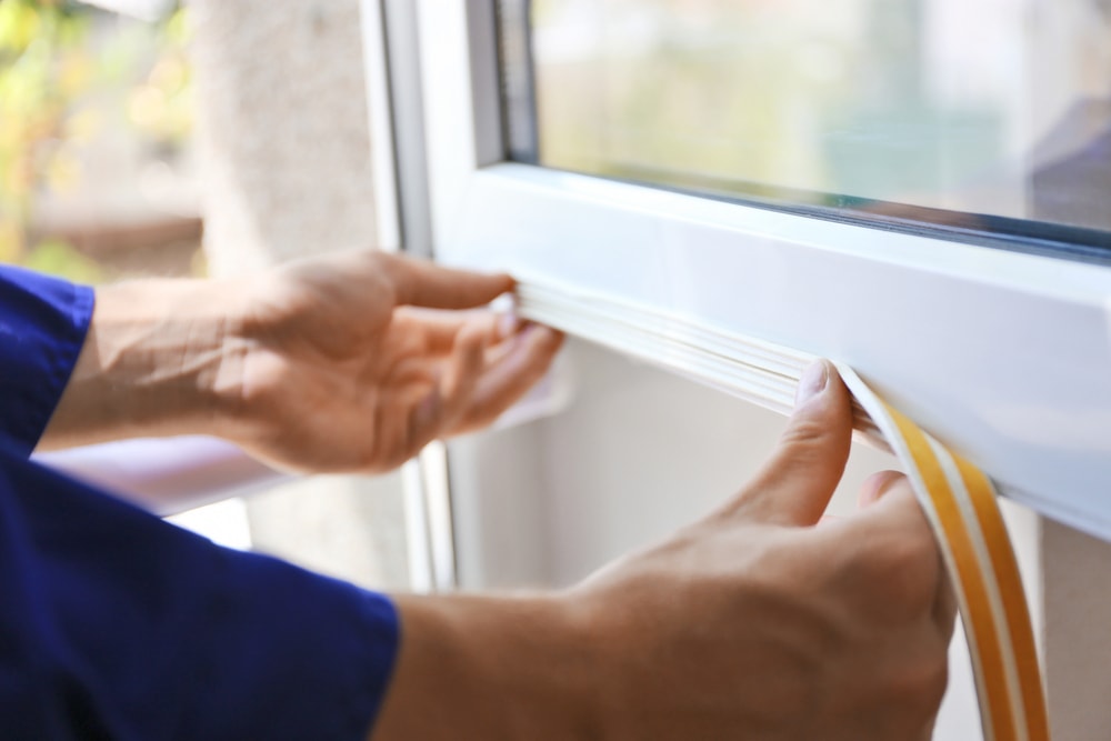 Person putting seal in a window
