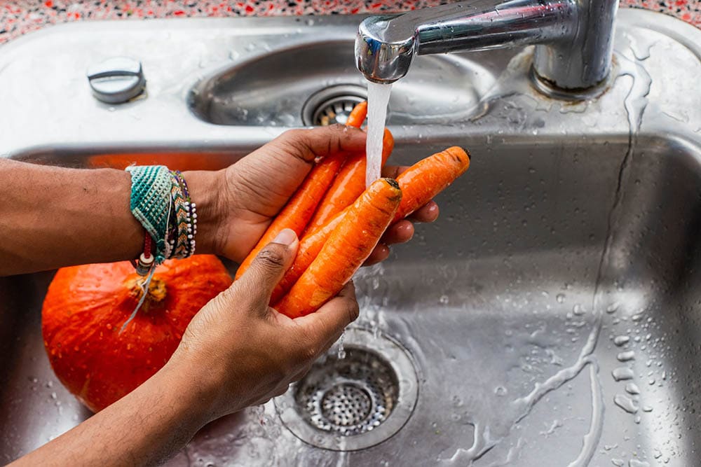 Washing carrots with water_Louis Hansel_Unsplash