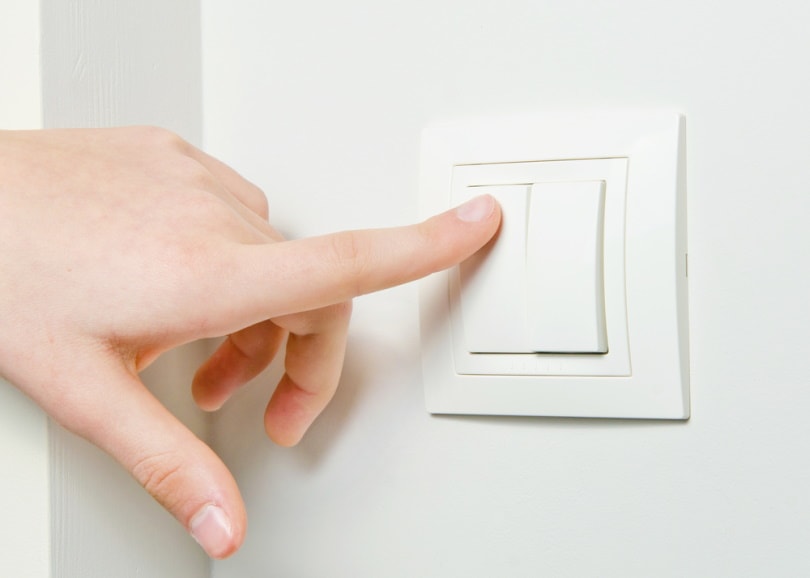 hand turning on light