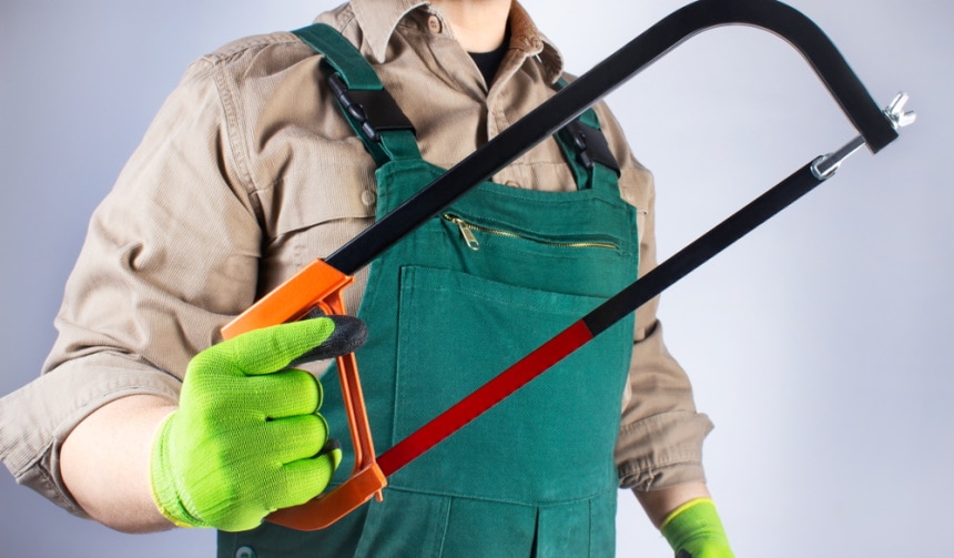 man holding hacksaw