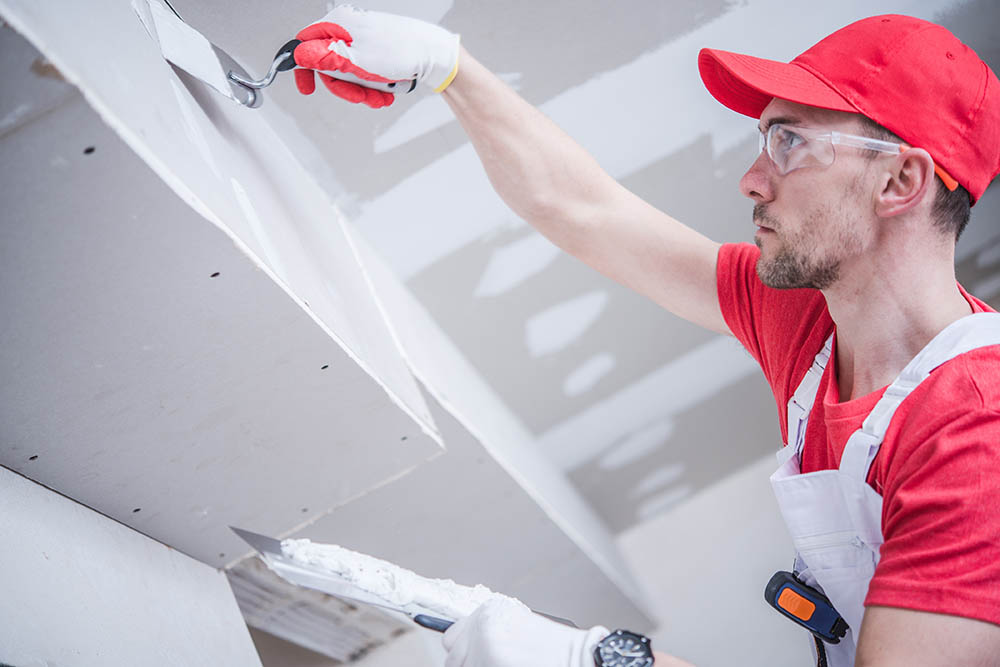 man patching drywall