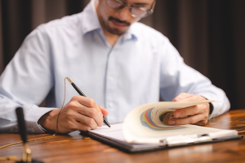man signing permit
