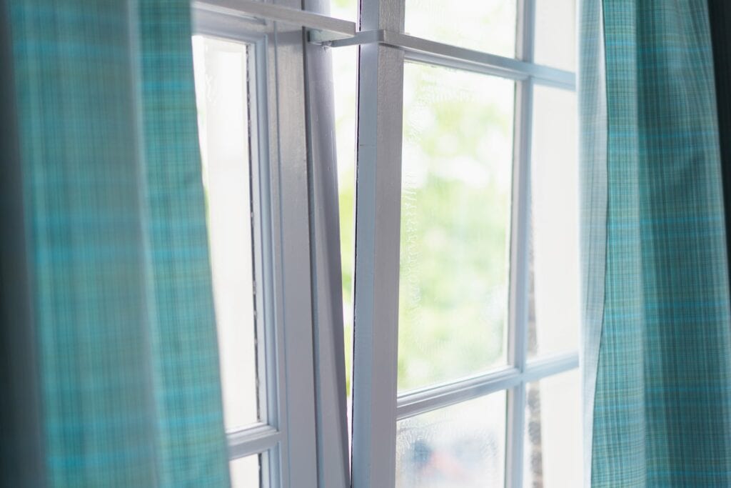 white window with green curtain