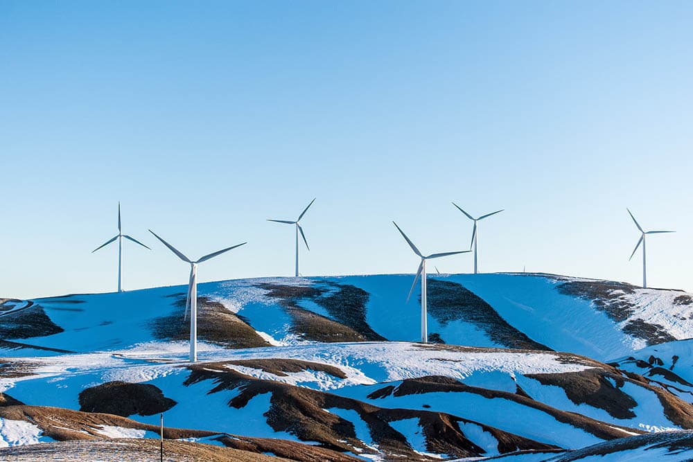 windmills on a hill during winter