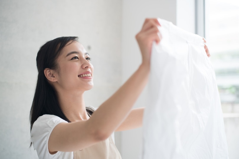 woman holding white clothes