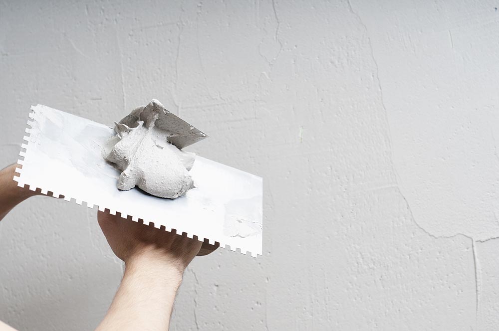 applying plaster on the wall