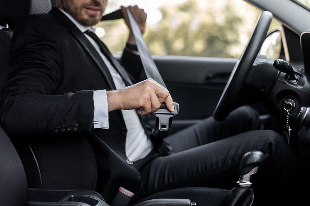 Businessman fasten seat belt in his car