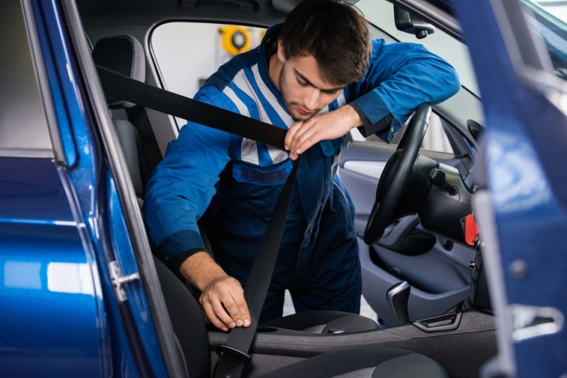 man checking car seat