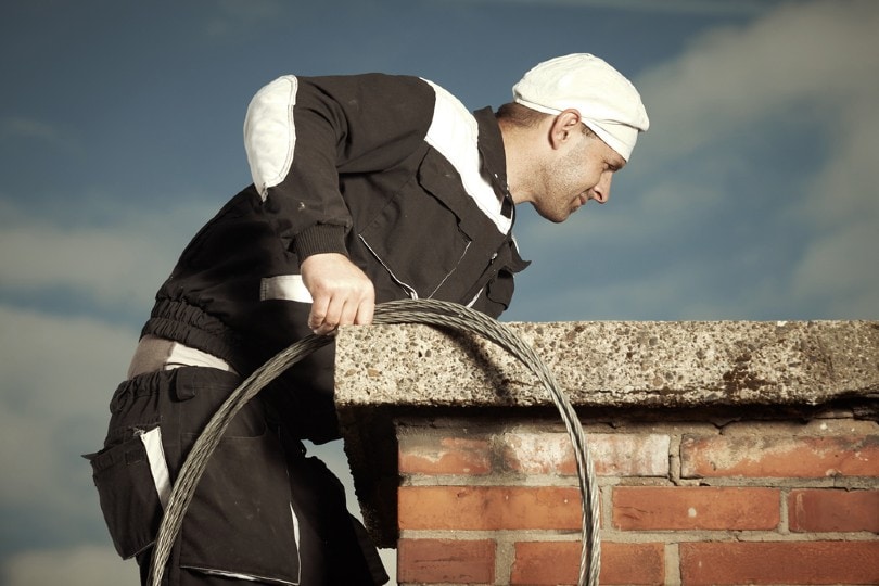man cleaning chimney