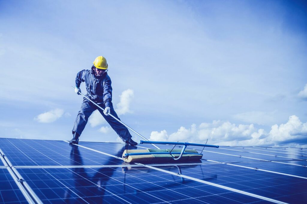 man cleaning the solar panel