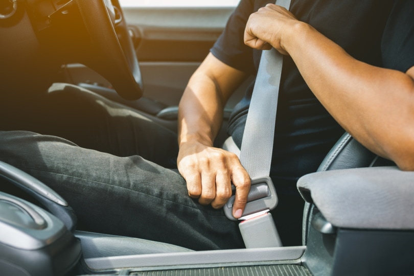 man fastening seatbelt
