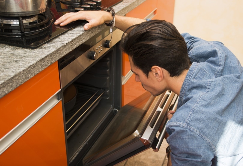 man using an oven