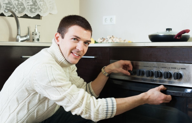 man using an oven
