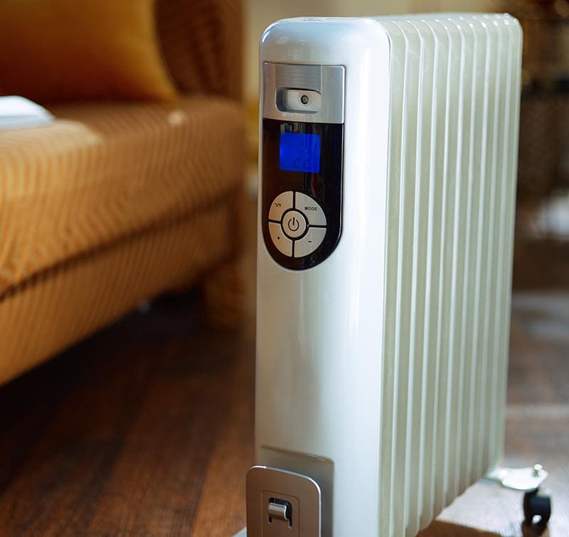 modern floor white electric oil radiator with thermostat in the modern living room