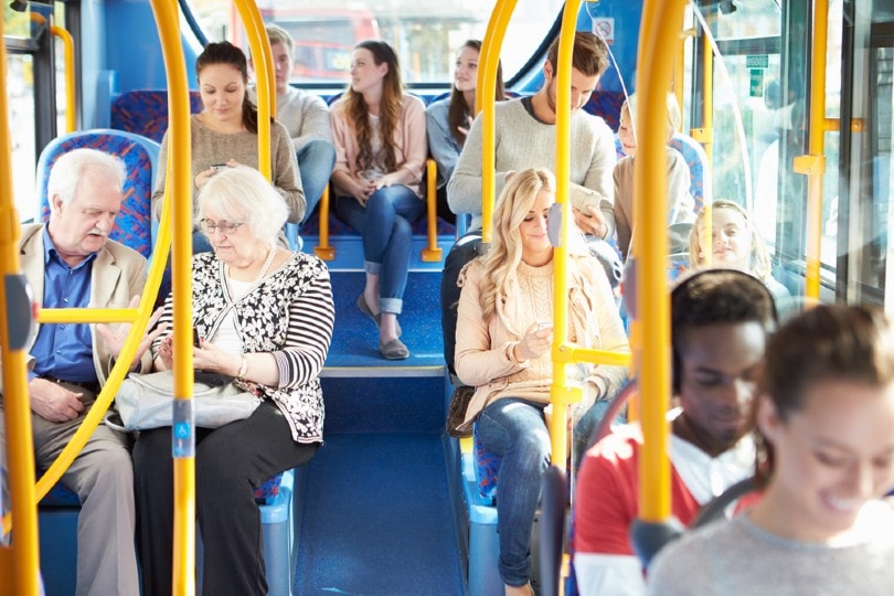 people riding on a public bus