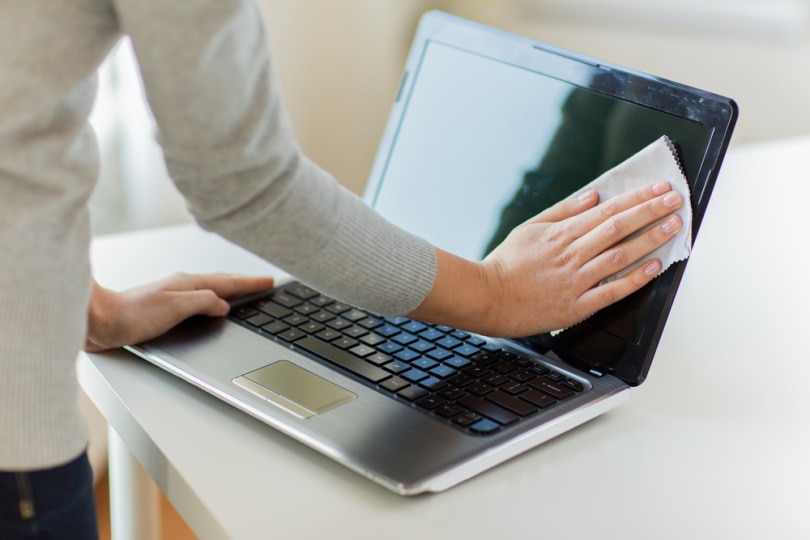 woman cleaning laptop