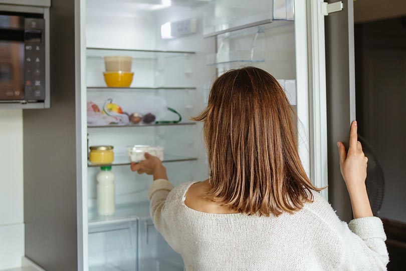 woman opening the refrigerator