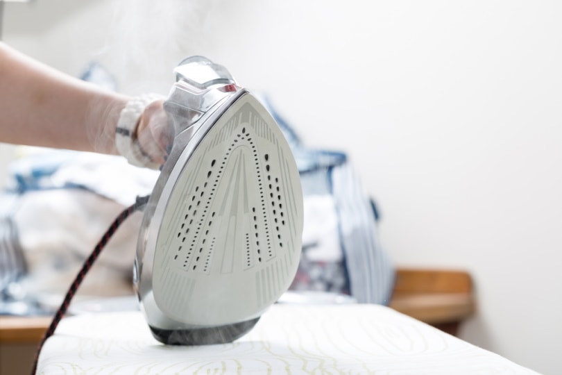 woman using electric iron