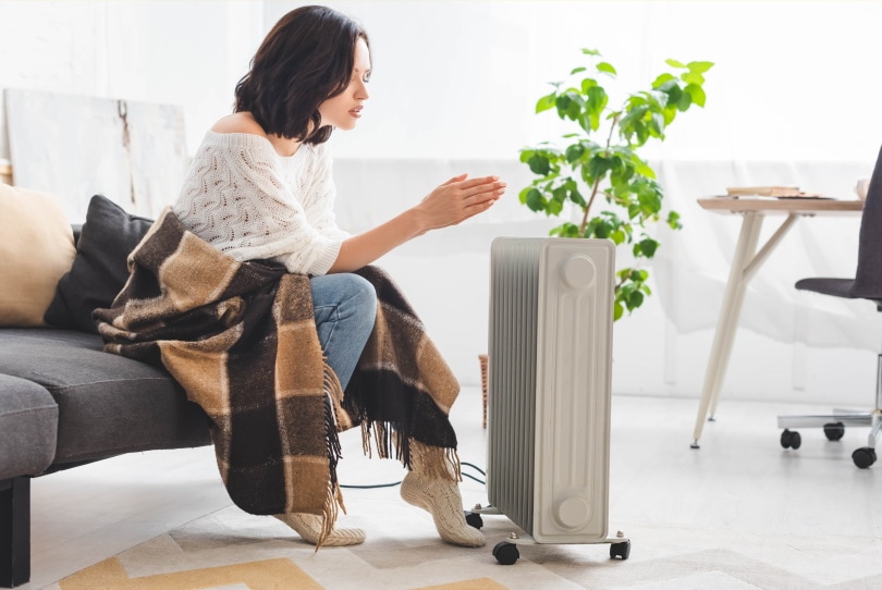woman using space heater