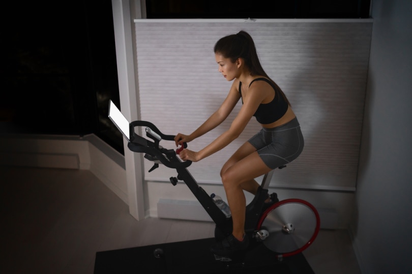 woman using stationary bike