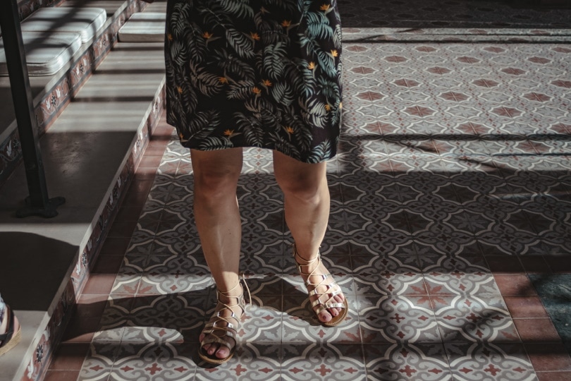 woman walking in mosaic tiles