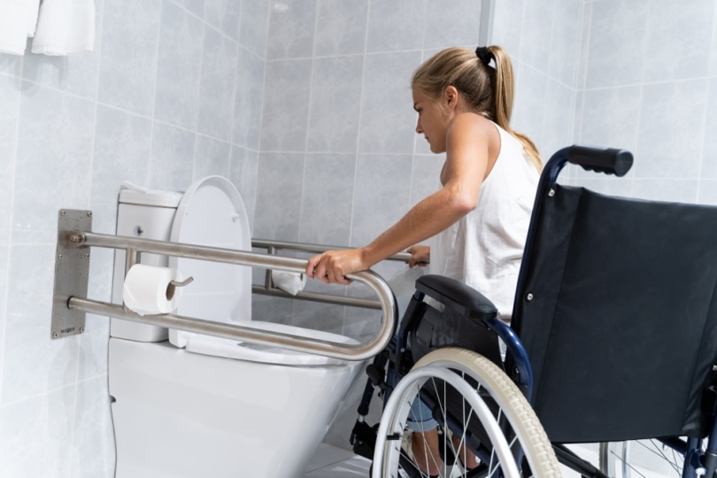 woman with disability using toilet