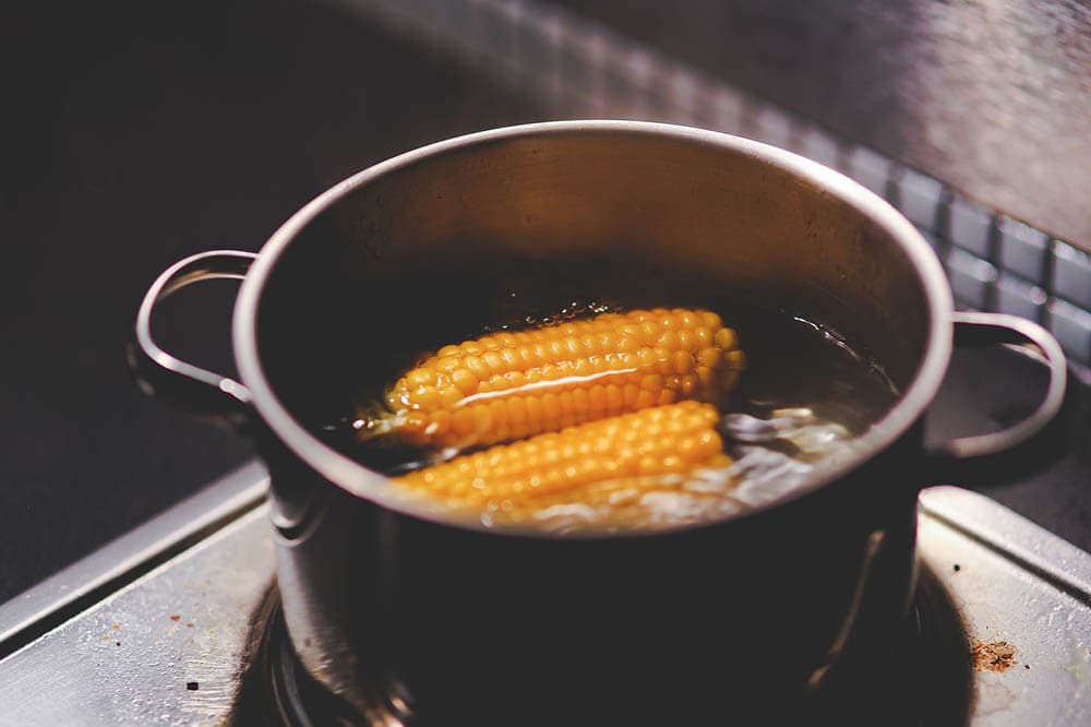 Cooking and boiling corn with water