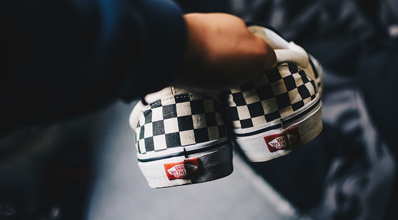 Holding a pair of shoes
