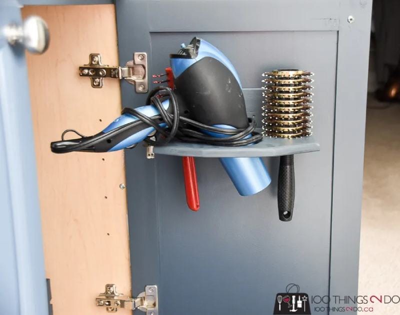 In-cupboard hair dryer holder