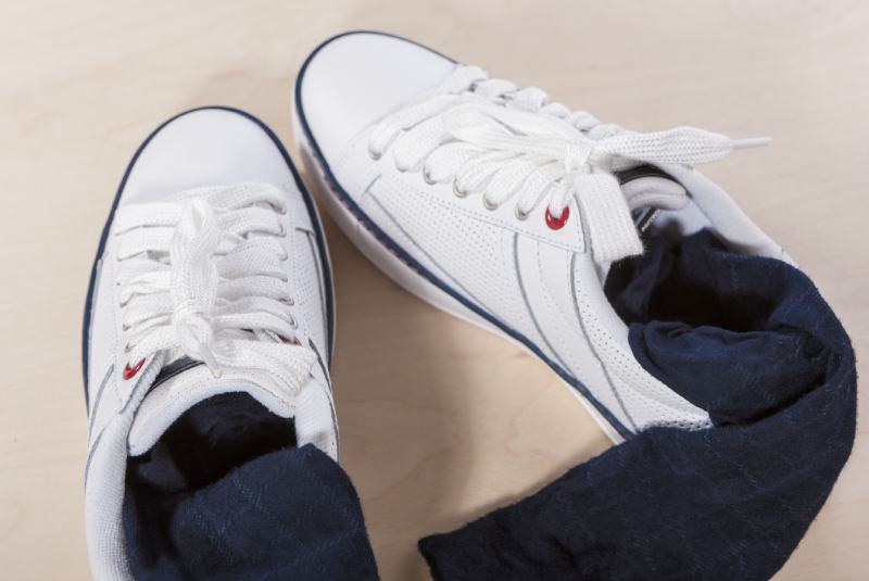 Pair of White Trainers with Socks Inserted Inside