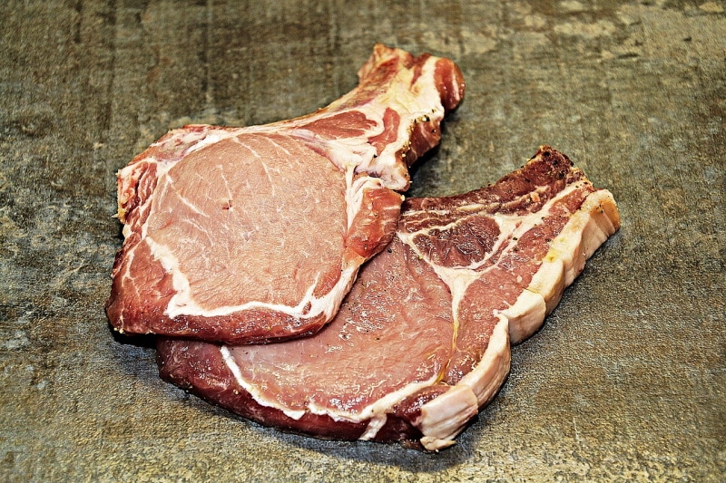 Slabs of pork chop on a rough surface