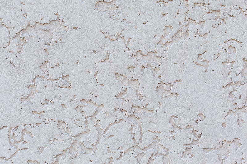 Texture of white wall with decorative stucco