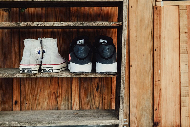 Two Pairs of Gray and Black Sneakers on Rack