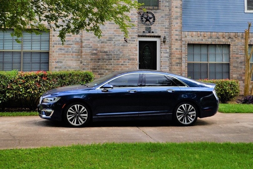 a blue sedan parked on a driveway
