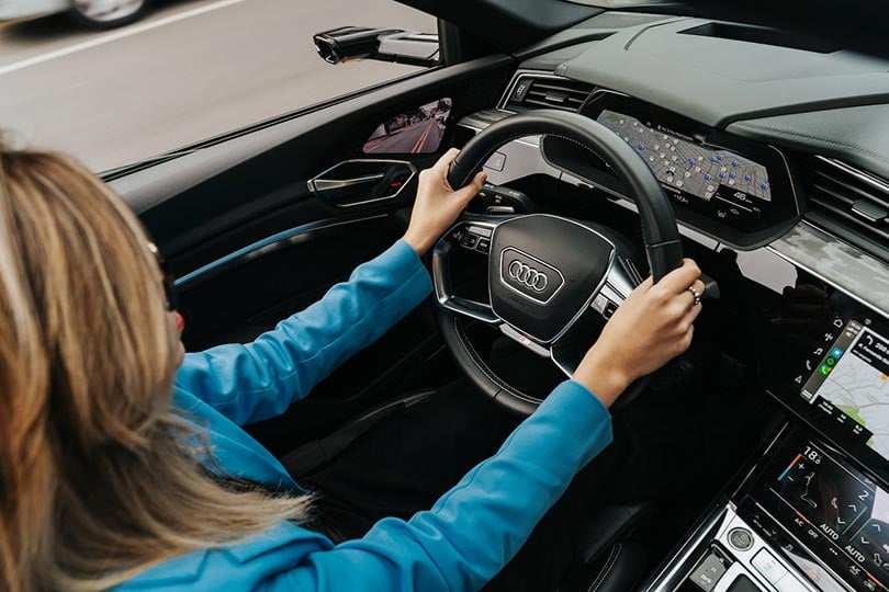 a woman driving a new audi car