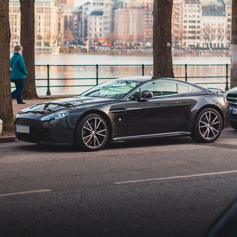 black Aston Martin DB11 on the street