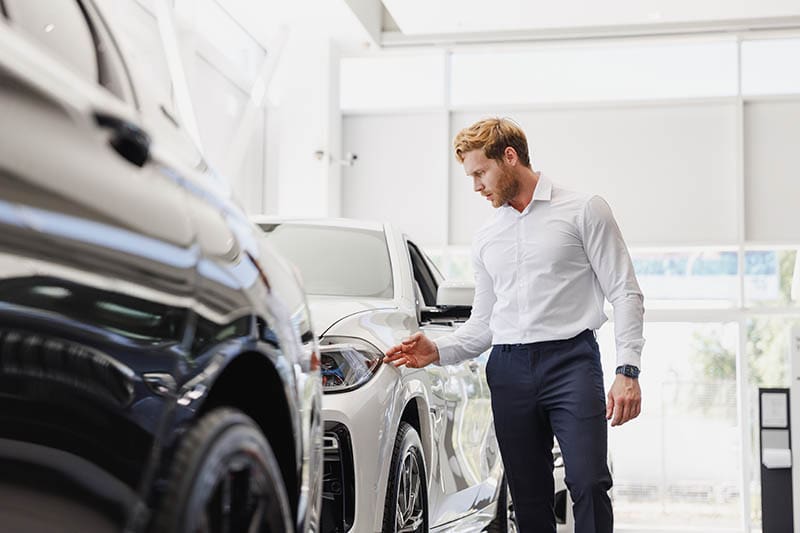 buyer inspecting a car on showroom