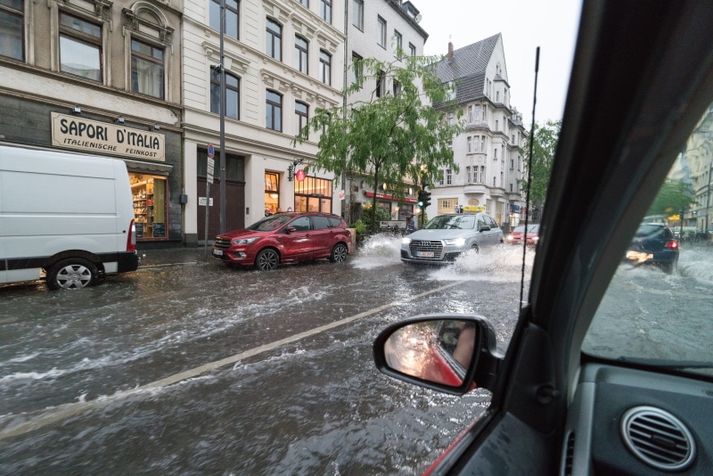 cars passing in flooded street