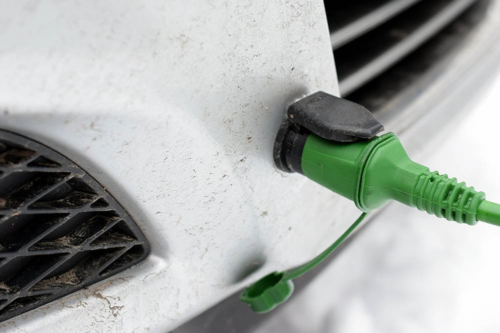 close up engine block heater plugged to car