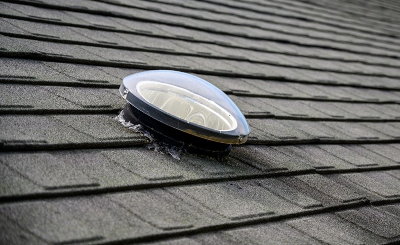 close up of a dome shaped solar tube on roof