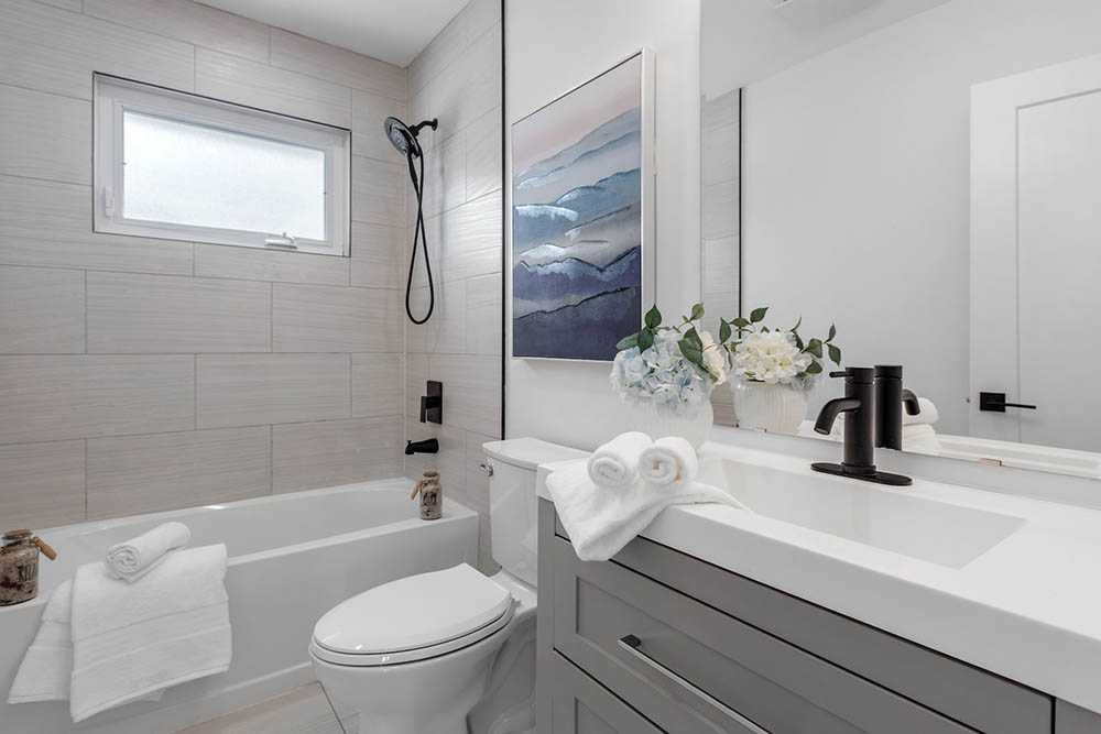 elongated toilet beside the bathtub