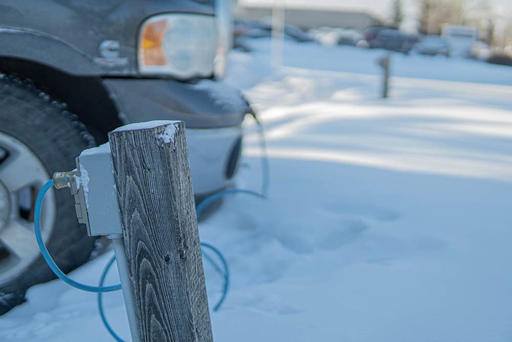 engine block heater plugged in front of the car