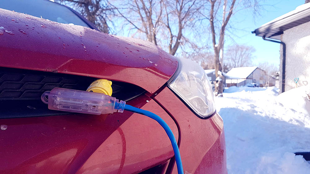 engine block heater plugged in red vehicle