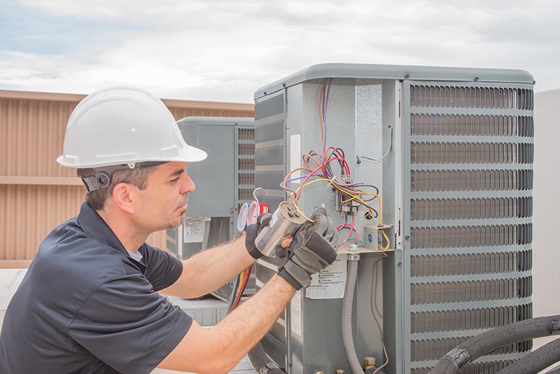 HVAC technician fixing the unit