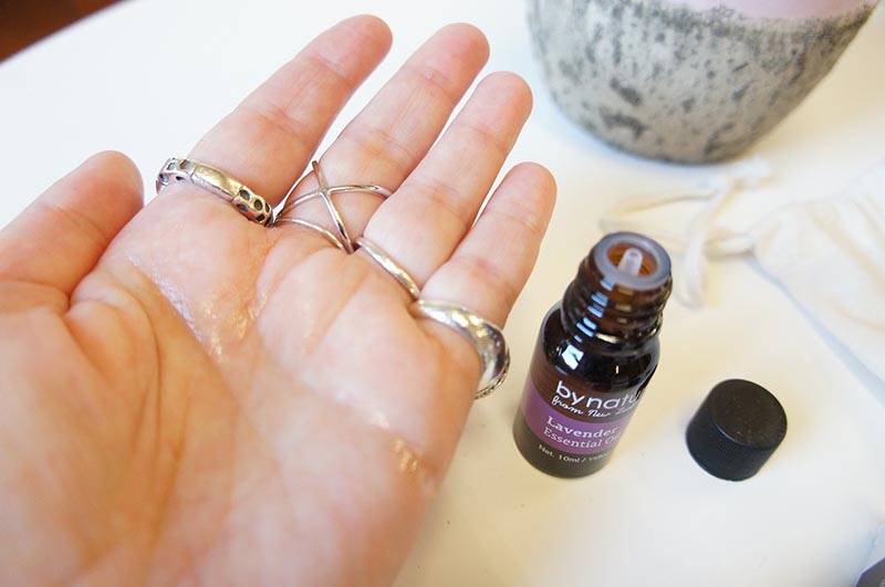 lavender essential oil beside the hand