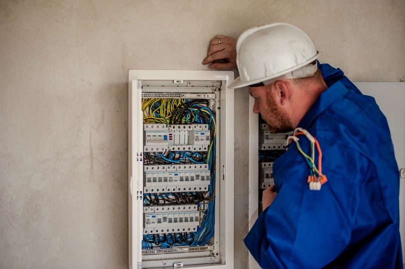 man checking electrical panel