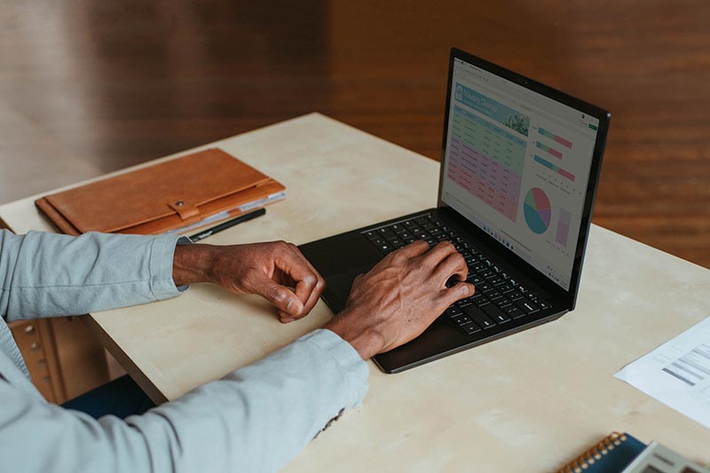 man checking his investments on his laptop