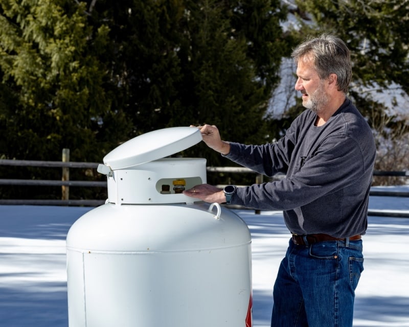 man checking propane tank
